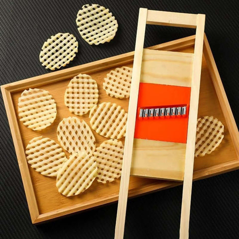 Wave waffle crinkle cutter set with wooden frame and metal blade; round lattice-cut potato chips on tray.