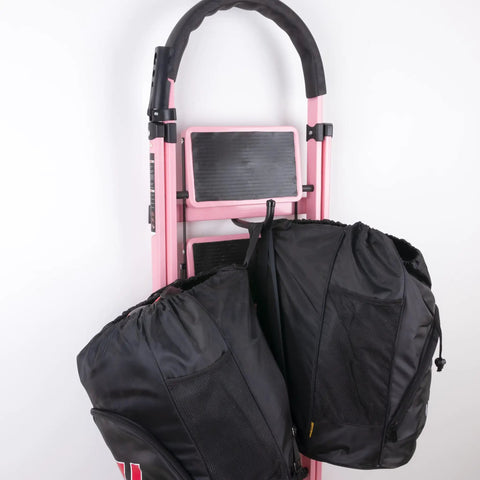 Beast Mode Heavy Duty Wall Hooks 4 Pack Black 8 Inch Long Hangers Thick Carbon Steel Garage holder for bags mounted on pink dolly.