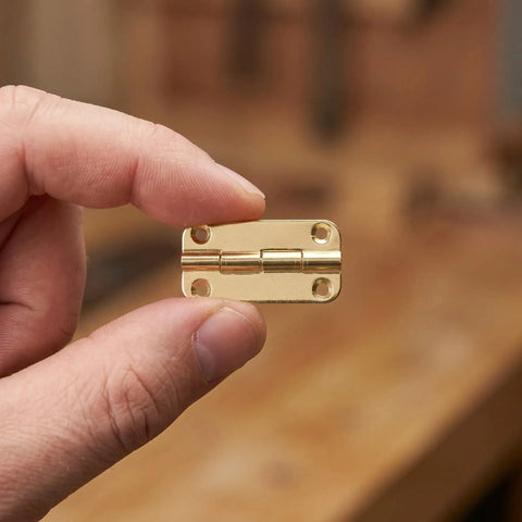 Small Antique Gold Cabinet Hinges Set With Rounded Corners And Four Hole Vertical Iron Mounting in hand