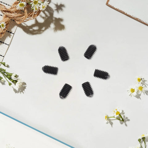 Rock Solid M4x6 Stainless Steel Ball Point Spring Plunger Set Screws 50 Pieces displayed on a white surface with flowers.