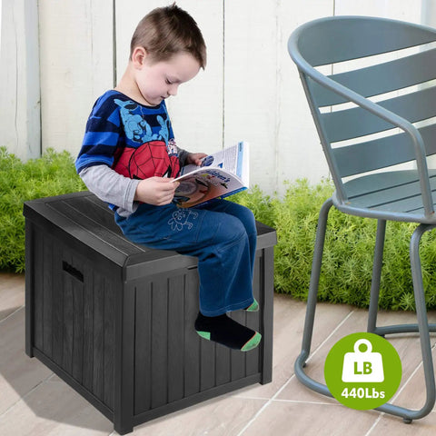Child sitting on 52 Gallon Outdoor Storage Box Deck Box Weatherproof Bench Black That Doubles as Extra Seating Waterproof Patio Chest Heavy Duty 440 Lb Capacity For Patio Use