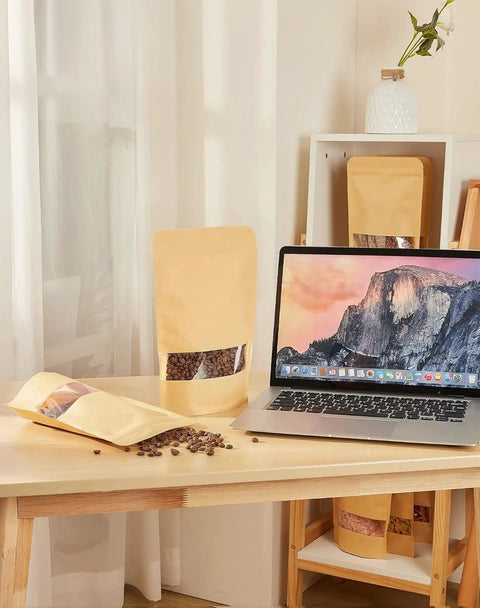 100 Pcs Kraft Stand Up Pouches With Window 3.5 By 5.5 Inch Zipper Food Storage Bags displayed next to a laptop on a table