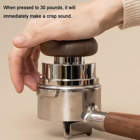 Dead Simple Setup 58mm Espresso Tamper Kit; close-up of aluminum tamper with wooden handle in use.