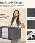 Six Pack Super Sturdy Closet Storage Bins With Lids Foldable Wardrobe Organizers Featuring Clear Window Zippered Closures And Rock Solid Handles holding gray storage bin with reinforced handles.