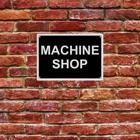 Top Tier Weatherproof Osha Machine Shop Sign 8X12 Inches on a brick wall, black with white text, weatherproof plastic material.