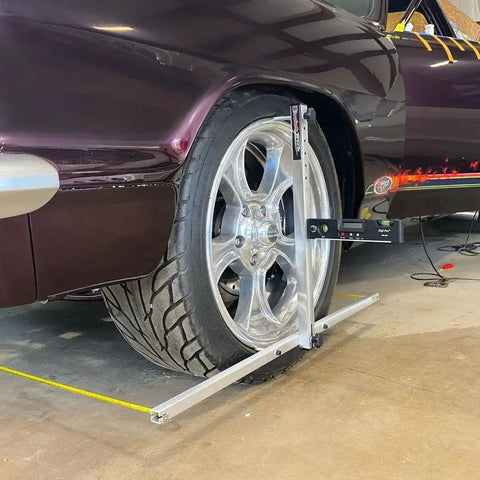Slick Portable Wheel Alignment Kit For 13 To 18 Inch Tires measuring caster and camber angles on a car wheel with digital gauge.