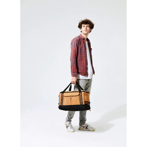 Person holding the Road Ready Three In One Rear Rack Bag That Transforms From Backpack To Duffle To Pannier 37L Capacity.