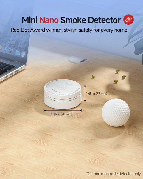 Mini Nano Smoke Detector next to a golf ball on a wooden surface, showcasing sleek design for home safety.