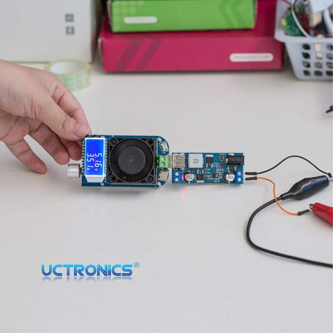Plug And Play Dual USB 5V Buck Converter From 9V To 36V Input With Stable 5V Output Up To 6A, 18W To 30W on a table.