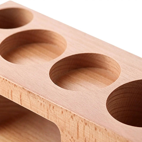 Premium 58 Mm Espresso Tamping Station Crafted From Warm Natural Wood with recessed areas for tamper storage.
