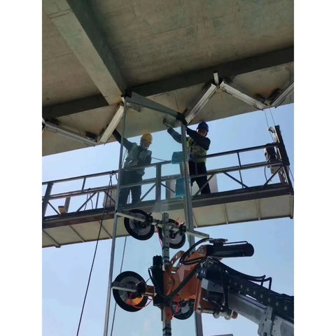 Two workers on a lift using the Workhorse Electric Glass Vacuum Lifter With Game Changing Suction Technology for glass installation.