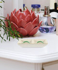 Elite Gold Trimmed Ceramic Jewelry Tray Featuring Mr And Mrs Pattern Double Grid Layout For Wedding Bands And Lipstick Small Trinket Dish on countertop with floral decor.