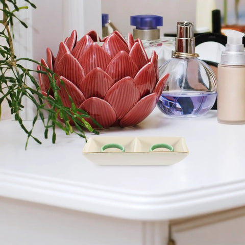 Slick Ceramic Jewelry Tray Featuring A Double Grid Ring Holder And Classy Gold Trim Trinket Dish For Your Nightstand Vibe And Staple Small Daily Organizer on a bedside table with decorative items.