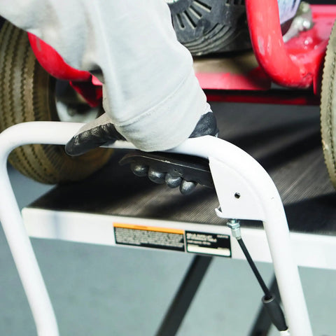 Person operating the hydraulic lift handle of a Heavy Duty Hydraulic Table Cart With Fast Two Speed Lift And 1000 LB Capacity.