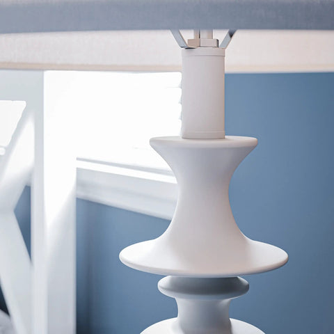 Close-up of Claiborne Floor Lamp With Gloss White Finish For A Clean Modern Vibe In Living Rooms, showcasing Nordic inspired detail.