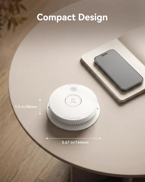 Heavy Duty Photoelectric Smoke Detector And Hardwired Fire Alarm With Interconnected Design And Reliable Battery Backup For Hassle Free Home Safety And Rapid Smoldering Fire Alerts In A Six Pack on a table next to a phone.