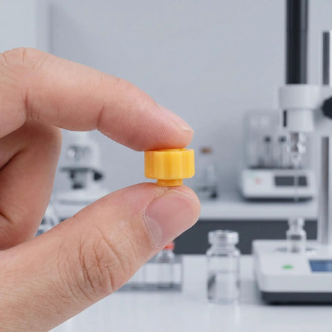 70 Pack Plastic Luer Lock Syringe Needle Tip Caps For Lab And Industrial Use Airtight Seal Easy Grip Leakproof Storage For Safe Sample Handling And Quick Dispensing, yellow cap held by hand