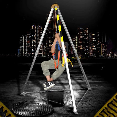 Rock Solid Heavy Duty Confined Space Tripod With 1800 Pound Rescue Winch And Self Locking Fall Arrest System, in use with a worker suspended safely.