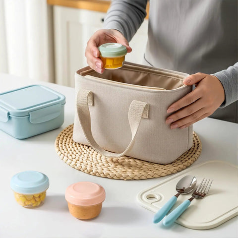 Person placing a colorful sauce cup into a lunch bag from the Eight Pack 2 Oz Salad Dressing Containers To Go With Lids For Lunch Boxes And Bento