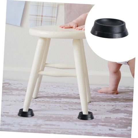 Tough As Nails Rubber Floor Cups With High Grip Non Skid Base For Rolling Office Chairs And Bed Wheels Straight Forward Easy Install Home Setup Floor Savers No Damage Guarantee Set Of Twelve Pieces under a white wooden stool on a wooden floor.
