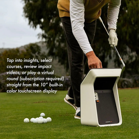 Golfer using All In One Golf Launch Monitor And Simulator Bundle with 10-inch color display on a grassy course.