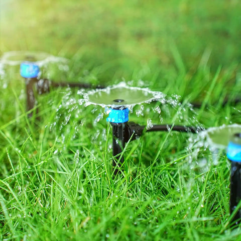 50 Pack 1/4 Inch Drip Emitters With 5 Inch Stakes Adjustable 360 Degree Water Flow Vortex Sprayer Drippers in action on grass