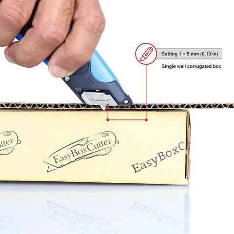 Heavy Duty Box Cutter With Three Adjustable Blade Depths And Precision Edge Guide cutting through a brown cardboard box.