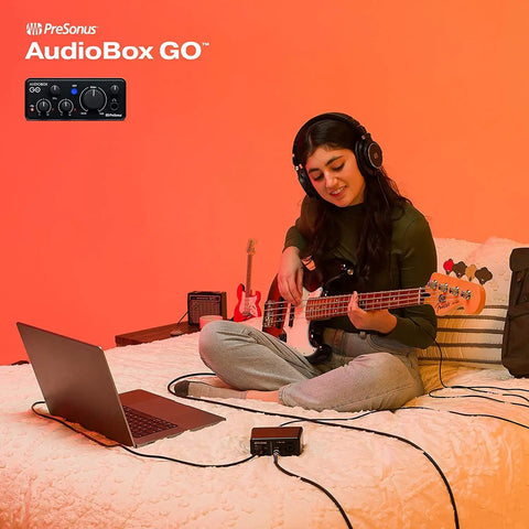 Person uses Ultra Compact USB C 2x2 Audio Interface Bundle With Condenser Microphone Studio Headphones Grab And Go Boom Stand Pop Filter XLR Cable And Studio One Music Production Software for music production on bed