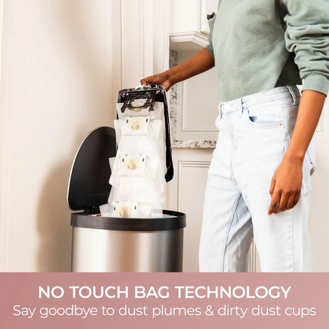Kenmore Intuition Bagged Upright Vacuum With Hair Eliminator Brushroll being emptied into a bin with no touch bag technology.