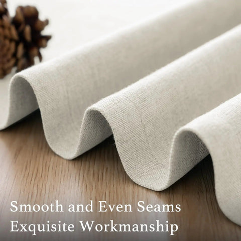 Close-up view of Soft Faux Linen Curtains 63 Inch Long material showing smooth seams and heather ivory color texture on wood surface.