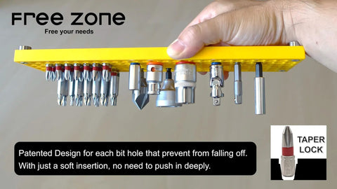 Hand holding a yellow Massive 158 Hole Bit Organizer Tray For One Quarter Inch Hex Bits And Drive Bit Adapters Red Toolbox Storage.