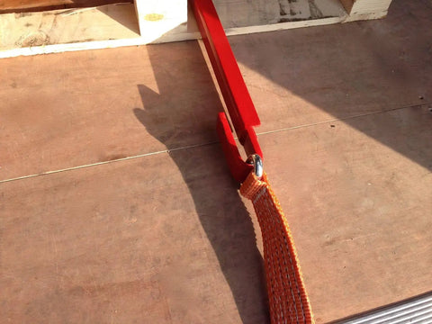 Heavy Duty Pallet Puller Bar With Three Point Seven Meter Strap Designed For Forklifts Featuring A Rugged Steel Hook And Thick Polyester Webbing on a wooden surface.