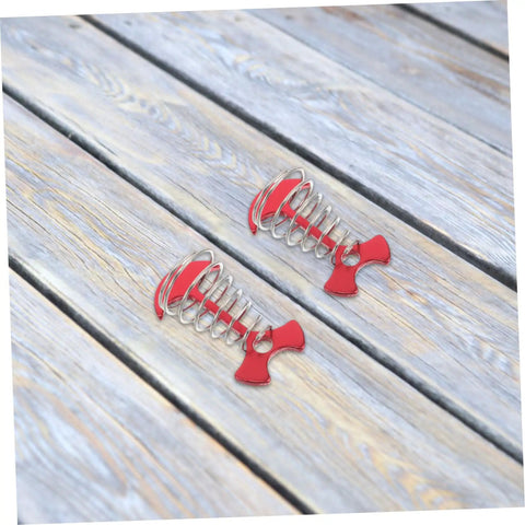 Heavy Duty Adjustable Aluminum Fishbone Tent Pegs And Rope Tighteners For No Sweat Awning Setup, Red and silver windproof anchors on wooden surface.
