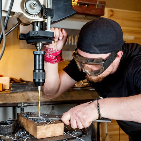 Person using a drill press with Titanium Coated Drill Bit Set With Hex Shank And 135 Degree Tip High Speed Steel Drill Bits Kit.