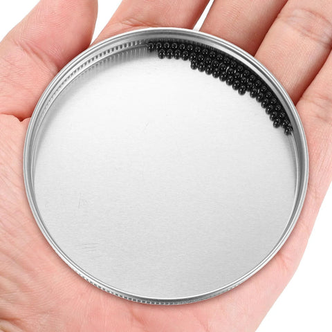 Ceramic bearing balls, black silicon nitride Si3N4, 2.381 mm (3/32 in), 200 pcs, in metal tin lid (front view).