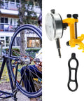Cyclist using Pro Bike Wheel Truing Stand And Rim Adjustment Tool alongside a dial gauge and wrench