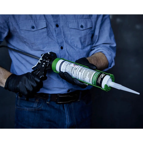 Fluid Applied STPE Liquid Flashing Sealant In 29 Oz Cartridge For Rough Openings And Door Window Installations held in gloved hand.