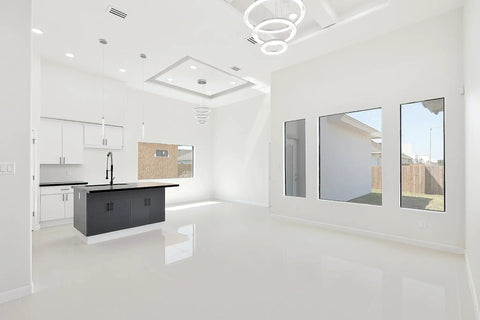Spacious modern room with light fixtures, large windows, and kitchen area, suitable for 24x8 White Modern AC Vent Cover Decorative Linear Slot Diffuser Register Grille For Ceiling, Walls, And Floors Dope Finish, Easy Installation, Keeps Airflow Smooth, Home Or Office Use.