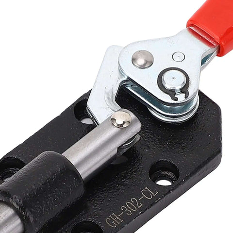 Close-up of push pull toggle clamp cast iron adjustable DIY woodworking clamp with plastic handle for welding installation.