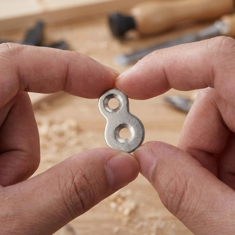 Hands holding Heavy Duty Dual Hole Rock Solid Desk Fasteners With Screws Clips 30 Pcs Iron Tabletop Connectors Prepunched No Burrs