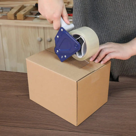 Applying Heavy Duty Clear Packing Tape 12 Pack Strong Acrylic Adhesive For Shipping Moving And Packaging 1.8 Mil Thick 72 Yard Rolls to a cardboard box.