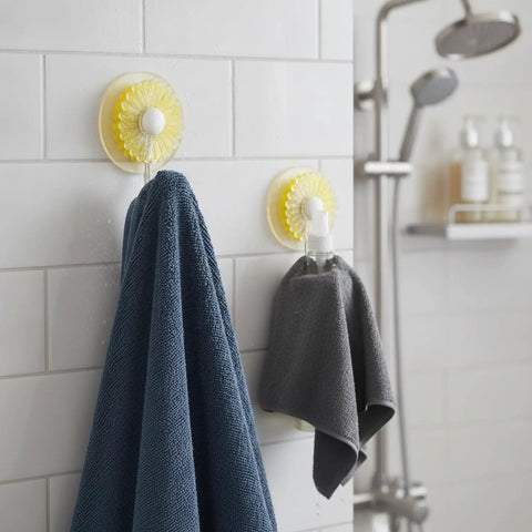 Rock Solid Adhesive Wall Hooks 1 Pack Killer Hold on ceramic tile holding a blue towel and gray cloth in a bathroom.
