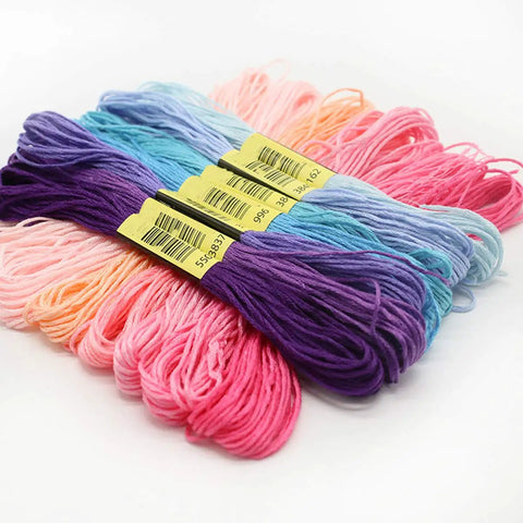 Totally Sick Rainbow Embroidery Floss Assortment Featuring Fifty Smooth Cotton Threads arranged in vibrant pink, purple, and blue skeins.