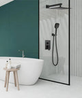 Modern bathroom with Dope Matte Black 10 Inch Square Rain Shower System, handheld spray, wall mount faucet, and glass enclosure.