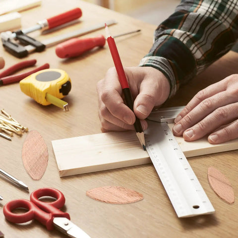 Beechwood Wood Joiner Biscuits Mixed Sizes Zero Ten Twenty Three Hundred Piece Knockout Kit, measuring wood with ruler and pencil for woodworking.