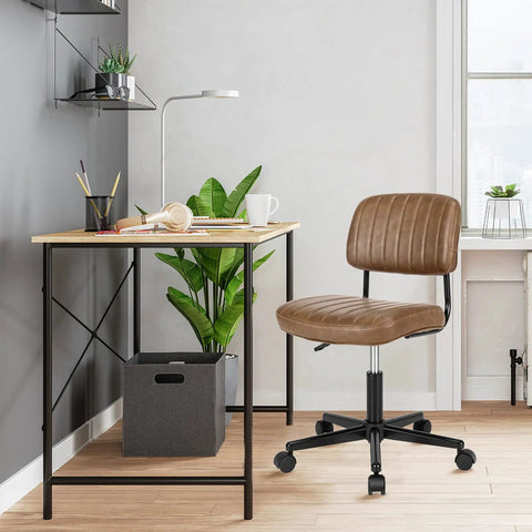Slick Armless Desk Chair With Easy Glide Wheels, Top Tier PU Leather Task Seat in home office setting with desk and plant.