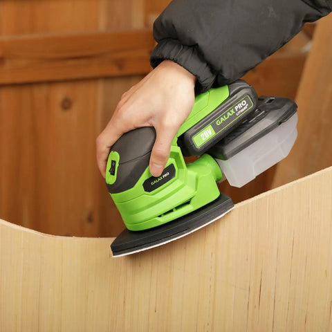 Garage Shop Ready Compact Detail Sander With 1.1A Motor Delivers 14,000 OPM sanding a wooden edge, includes dust bag and soft grip handle.