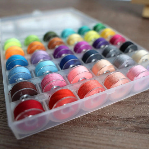 Top Shelf 72 Piece Sewing Thread Kit With 36 Vibrant Polyester Shades And Matching Bobbins arranged in a clear storage box.