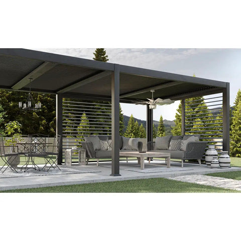 Chic Slick Farmhouse Ceiling Fan With A Tough Antique Nickel Finish And Massive Twelve Blade Windmill Design For That Fresh Modern Rustic Vibe Inside Open Living Spaces, viewed in a covered outdoor patio.