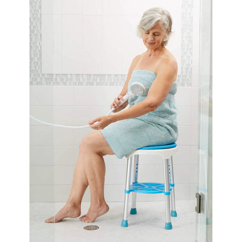 360 Degree Swivel Bath Stool With Cushioned Seat And Storage Tray Adjustable Rotating Shower Chair For Seniors And Adults Easy Entry And Exit From Tub, shown in use by a senior woman in a bathroom setting.